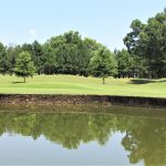 Panoramic view of a lush green golf course at Lane Creek Golf Club. Smooth