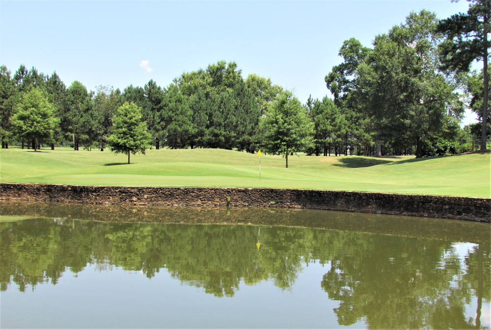 Panoramic view of a lush green golf course at Lane Creek Golf Club. Smooth