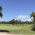 Panoramic view of a lush green golf course at Largo Golf Course. Smooth