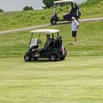 green grass with the flag in the hole.