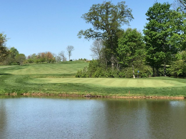 Panoramic view of a lush green golf course at Lassing Pointe Golf Course. Smooth