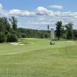 Panoramic view of a lush green golf course at Laurel Hill Golf Club. Smooth