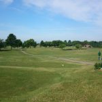 Panoramic view of a lush green golf course at Laurel Oaks Golf Club. Smooth
