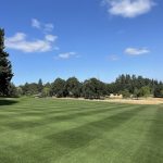 Panoramic view of a lush green golf course at Laurelwood Golf Course. Smooth