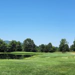 Panoramic view of a lush green golf course at Ledges Golf Club. Smooth