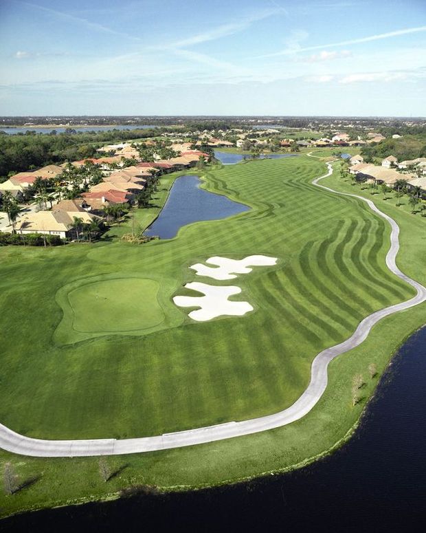 Panoramic view of a lush green golf course at Legacy Golf Club At Lakewood Ranch. Smooth