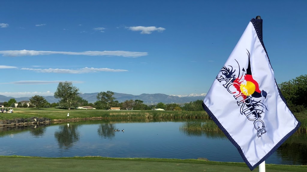 Panoramic view of a lush green golf course at Legacy Ridge Golf Course. Smooth
