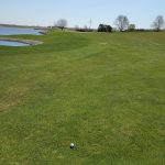 Panoramic view of a lush green golf course at Lenox Municipal Golf Course. Smooth