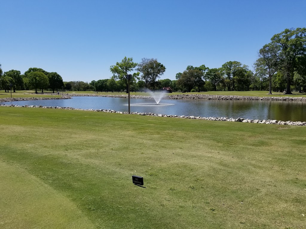 Panoramic view of a lush green golf course at Les Vieux Chenes Golf Course. Smooth