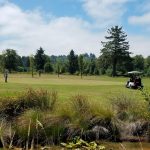 Panoramic view of a lush green golf course at Lewis & Clark Public Golf Course. Smooth