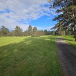 Panoramic view of a lush green golf course at Lewis River Golf Course. Smooth