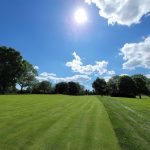Panoramic view of a lush green golf course at Lexington Country Club. Smooth