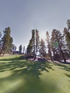Panoramic view of a lush green golf course at Liberty Lake Golf Course. Smooth