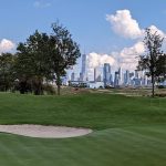 Panoramic view of a lush green golf course at Liberty National Golf Club. Smooth