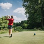 Panoramic view of a lush green golf course at Lick Creek Golf Course. Smooth