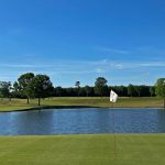 Panoramic view of a lush green golf course at Lil Mole Run Golf Course. Smooth