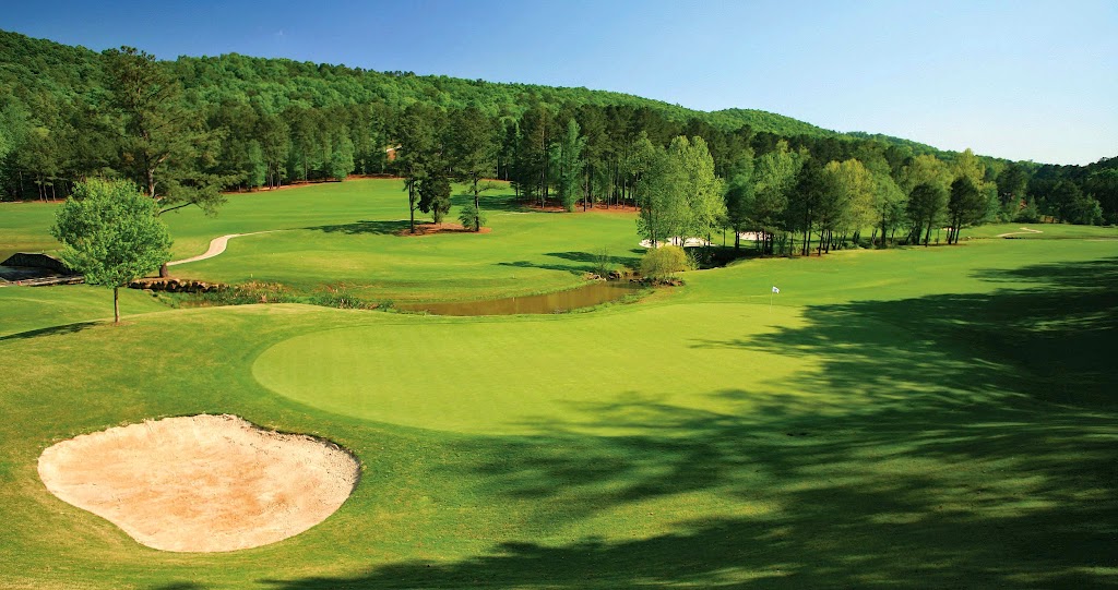 Panoramic view of a lush green golf course at Limestone Springs Golf Club. Smooth