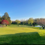 Panoramic view of a lush green golf course at Lincoln Country Club. Smooth