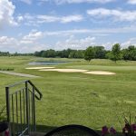 Panoramic view of a lush green golf course at Links At Echosprings. Smooth
