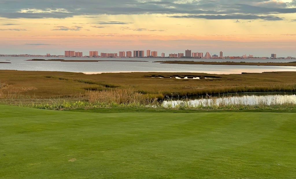 Panoramic view of a lush green golf course at Links At Lighthouse Sound. Smooth