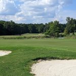 Panoramic view of a lush green golf course at Links At Redstone. Smooth