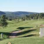 Panoramic view of a lush green golf course at Links At Sierra Blanca. Smooth