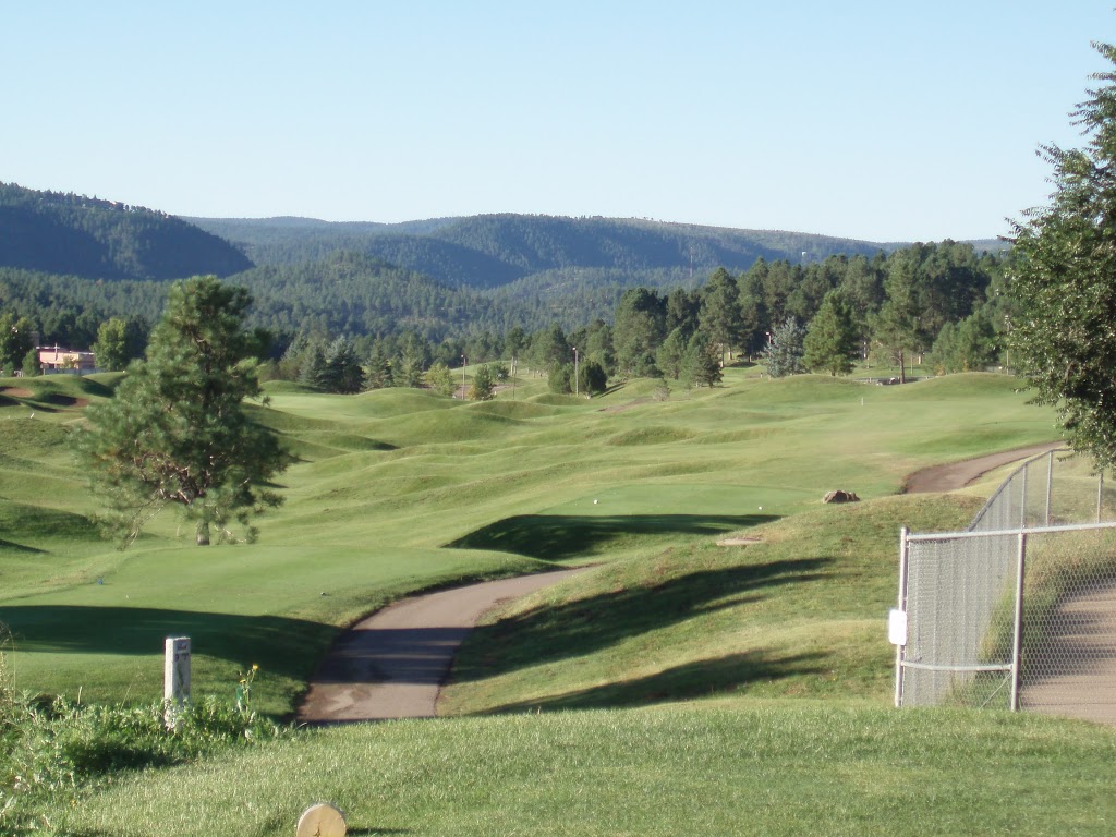 Panoramic view of a lush green golf course at Links At Sierra Blanca. Smooth