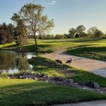 Panoramic view of a lush green golf course at Links Golf Course. Smooth