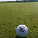 green grass with the flag in the hole.