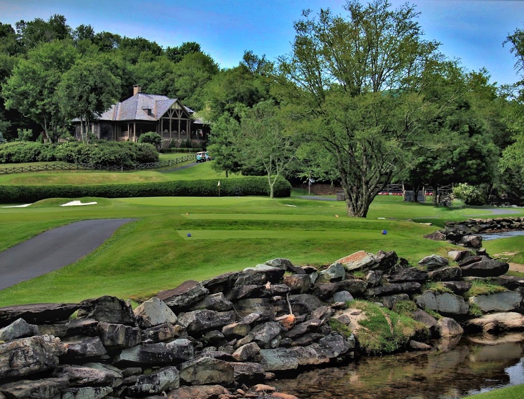 Panoramic view of a lush green golf course at Linville Golf Club. Smooth