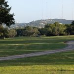 Panoramic view of a lush green golf course at Lions Municipal Golf Course. Smooth