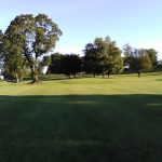 Panoramic view of a lush green golf course at Little Creek Golf Course. Smooth