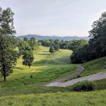 Panoramic view of a lush green golf course at Little Creek Golf Course. Smooth