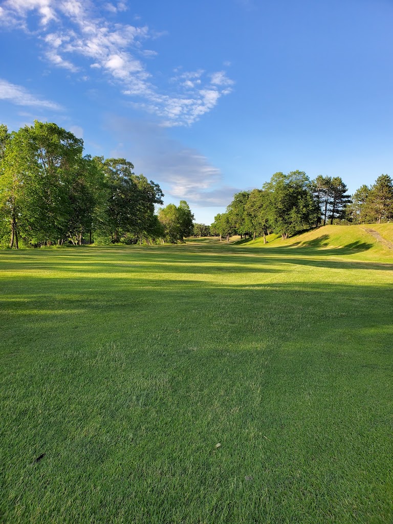 Panoramic view of a lush green golf course at Little Falls Golf Course. Smooth