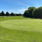Panoramic view of a lush green golf course at Little Harbor Golf Course. Smooth