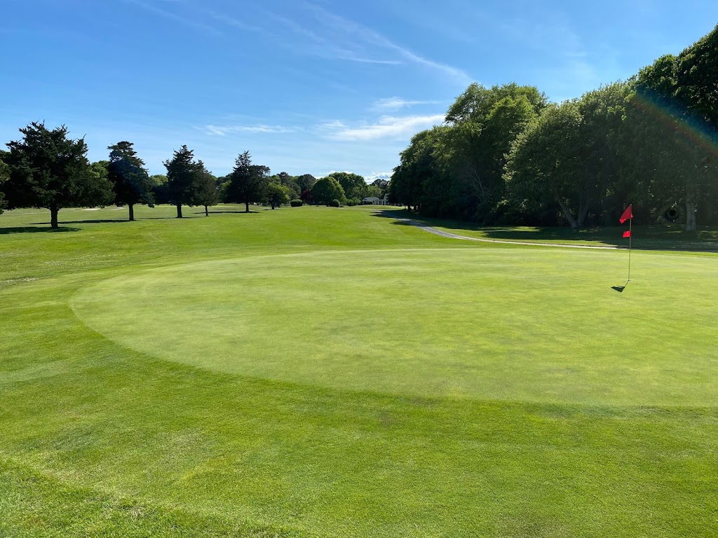 Panoramic view of a lush green golf course at Little Harbor Golf Course. Smooth