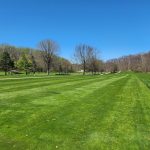 Panoramic view of a lush green golf course at Little Met Golf Course. Smooth