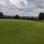 green grass with the flag in the hole.