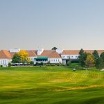 Panoramic view of a lush green golf course at Lone Tree Golf Club & Hotel. Smooth
