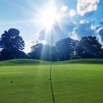 Panoramic view of a lush green golf course at Longhills Golf Course. Smooth
