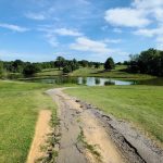 Panoramic view of a lush green golf course at Longview Golf Course. Smooth