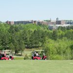 Panoramic view of a lush green golf course at Lonnie Poole Golf Course. Smooth