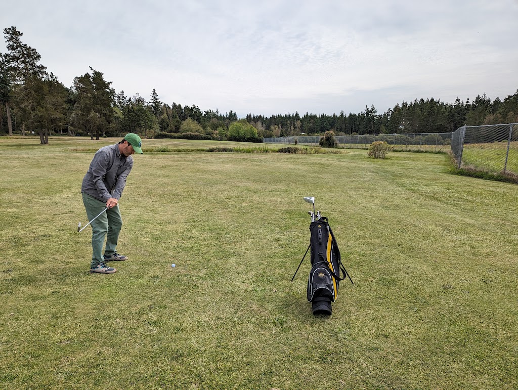 Panoramic view of a lush green golf course at Lopez Island Golf Club. Smooth