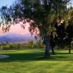 Panoramic view of a lush green golf course at Los Caballeros Golf Club. Smooth