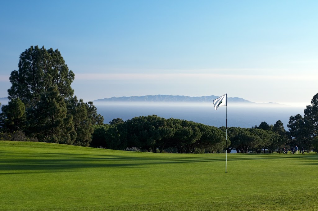 Panoramic view of a lush green golf course at Los Verdes Golf Course. Smooth