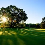 Panoramic view of a lush green golf course at Lost Nation Golf Course. Smooth