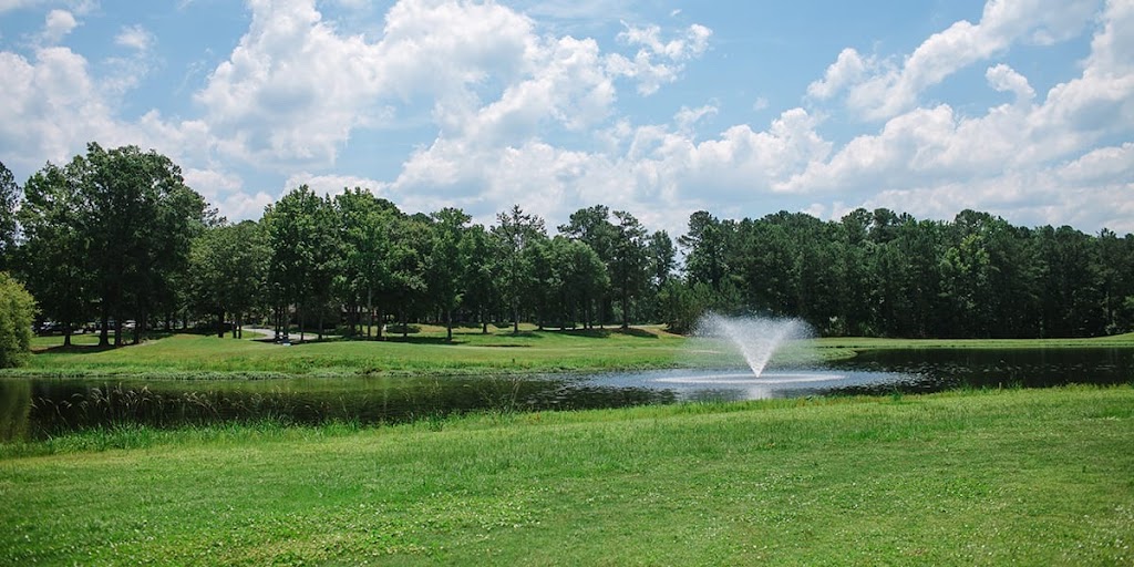 Panoramic view of a lush green golf course at Lost Plantation Golf Club. Smooth