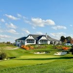 Panoramic view of a lush green golf course at Lost Rail Golf Club. Smooth