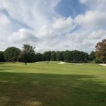 Panoramic view of a lush green golf course at Lost Springs Golf & Athletic Club. Smooth
