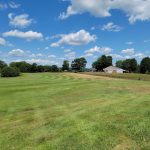 Panoramic view of a lush green golf course at Loudon Country Club. Smooth